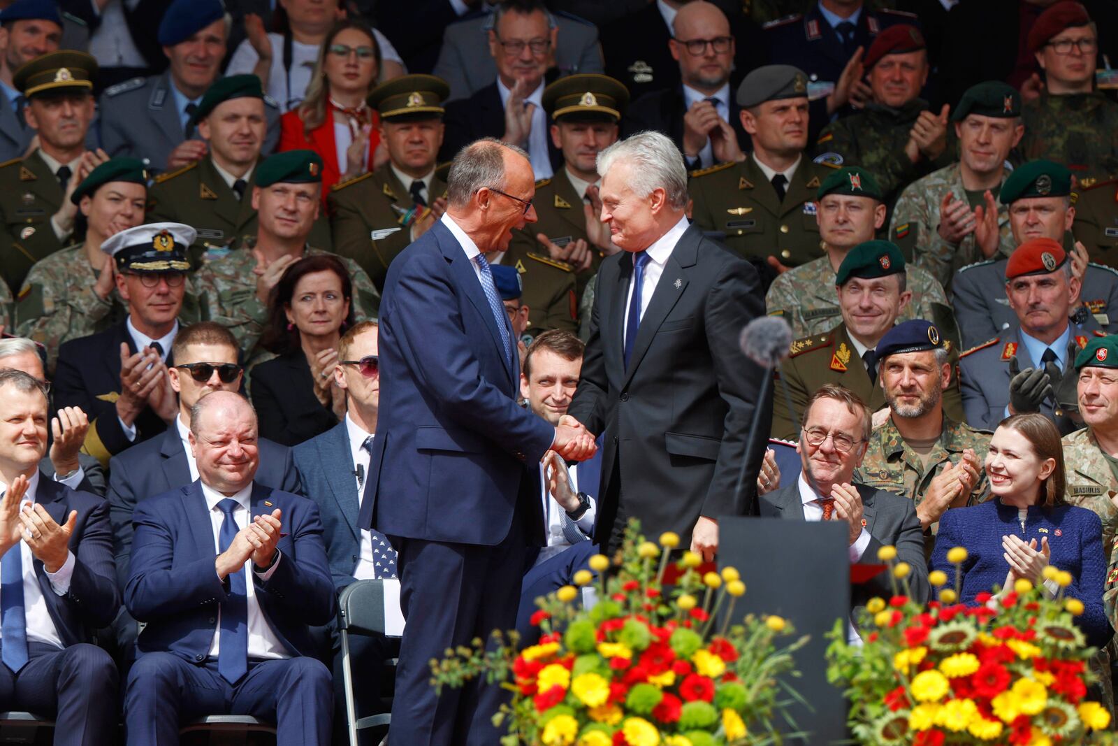 German Chancellor Friedrich Merz, left, shakes hands with Lithuania's President Gitanas Nauseda at a formal inauguration of a German brigade for NATO's eastern flank in Vilnius, Lithuania, Thursday, May 22, 2025. (AP Photo/Mindaugas Kulbis)