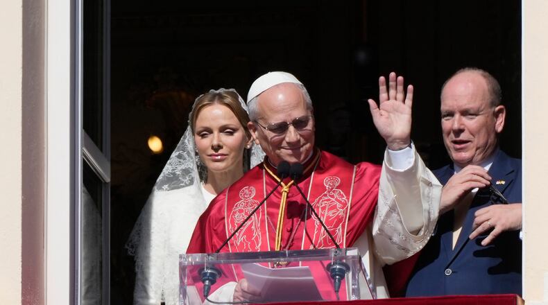 Pope Leo XIV, Princess Charlene of Monaco and Prince Albert II of Monaco appear at the Gallery of Hercules balcony at the Prince's Palace in Monaco-Ville, Monaco, Saturday, March 28, 2026.(AP Photo/Gregorio Borgia)
