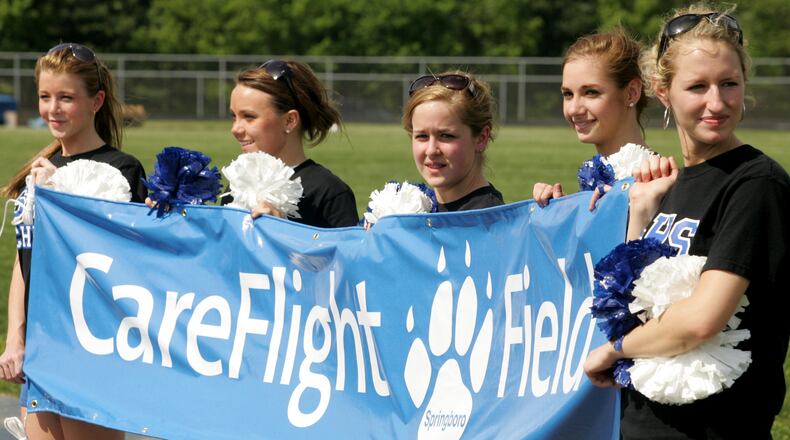 This 2007 file photo shows Springboro cheerleaders holding a banner with the name CareFlight Field, the new name of their football stadium. Now, the district is working on a new naming-rights deal.
