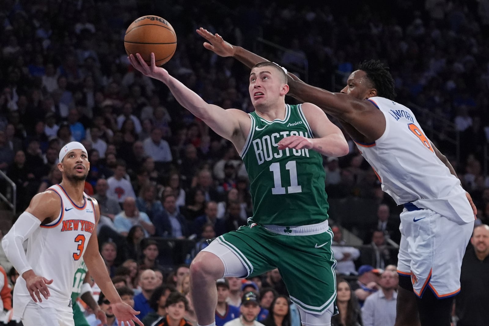 Boston Celtics' Payton Pritchard (11) drives past New York Knicks' OG Anunoby (8) during the second half of Game 6 in the Eastern Conference semifinals of the NBA basketball playoffs Friday, May 16, 2025, in New York. (AP Photo/Frank Franklin II)