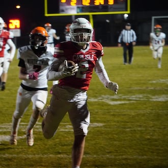 Carlisle’s Drew Conger (2) scores a touchdown against North Union in a Division V regional semifinal on Friday night at Laughlin Field. CHRIS VOGT / CONTRIBUTED
