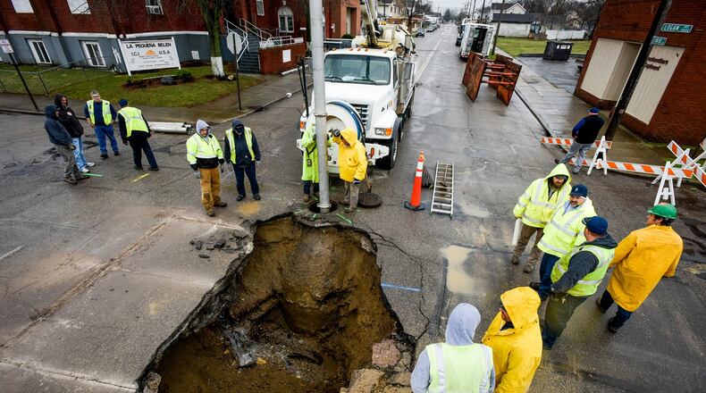 Middletown residents will see a 15 percent increase in sewer rates in 2018. City officials said part of the reason for the steep increases are due to the condition of Middletown’s sewer system. Pictured are crews repairing a water main break and sewer pipe collapse that caused a large sinkhole along Crawford Street in February. NICK GRAHAM/STAFF