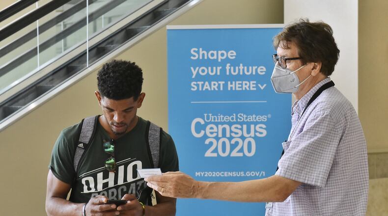 Census worker Don Nunnelley, right, helps Omar Contaro Raimundo with information to access the 2020 Census website to be counted Monday, August 31, 2020 at the Butler County Government Services Center in Hamilton. NICK GRAHAM / STAFF