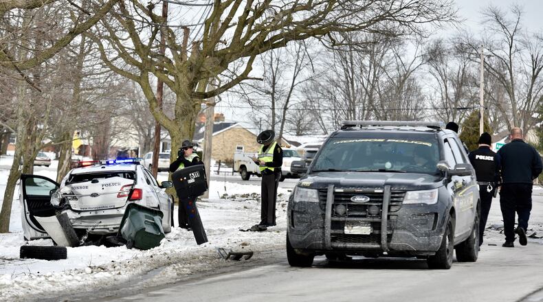 A Monroe police cruiser with the overhead flashing lights activated was struck in the rear by a pickup truck Tuesday, Jan. 22, 2019, on Ohio 4 south. The officer had just got into his cruiser and was about to clear the scene before being struck. The officer and the driver of the pickup truck were taken to area hospitals for injuries. The Ohio State Highway Patrol’s Hamilton post is investigating the crash. NICK GRAHAM/STAFF