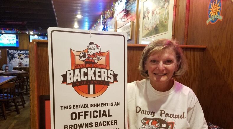 Geri Schick with the marker for the official Browns Backers location in Mac and Joes in Oxford. BRENNEN KAUFFMAN/STAFF