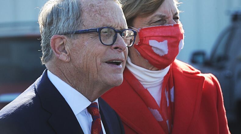 Gov. Mike DeWine and his wife, first lady Fran DeWine, will receive their first doses of the COVID-19 vaccine Feb. 2, 2021, the governor's office announced. The DeWines are pictured as they address the media before waiting in line to vote at the Cedarland Event Center in Cedarville on Nov. 3, 2020. MARSHALL GORBY\STAFF