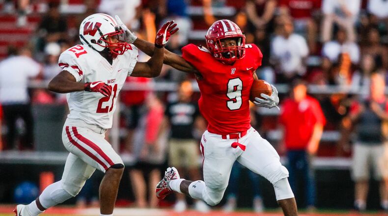 Fairfield’s JuTahn McClain stiff-arms Lakota West’s Hunter Anderson II as he carries the football during their game Sept. 14 at Fairfield Stadium. Fairfield won 37-3. NICK GRAHAM/STAFF