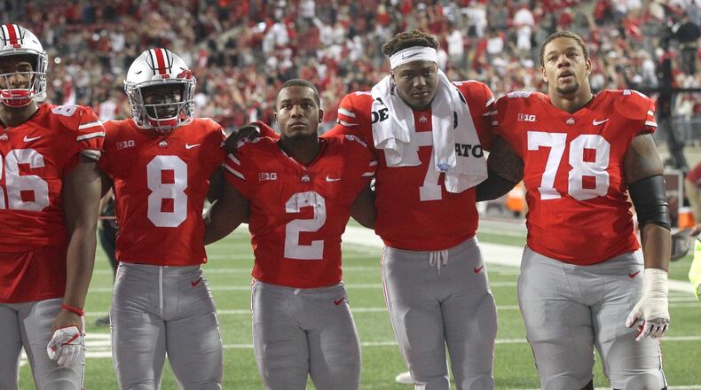 Ohio State players (left to right) Dre’Mont Jones, Kendall Sheffield, J.K. Dobbins, Dwayne Haskins and Demetrius Knox sing “Carmen Ohio” after a loss to Oklahoma on Saturday, Sept. 9, 2017, at Ohio Stadium in Columbus. David Jablonski/Staff