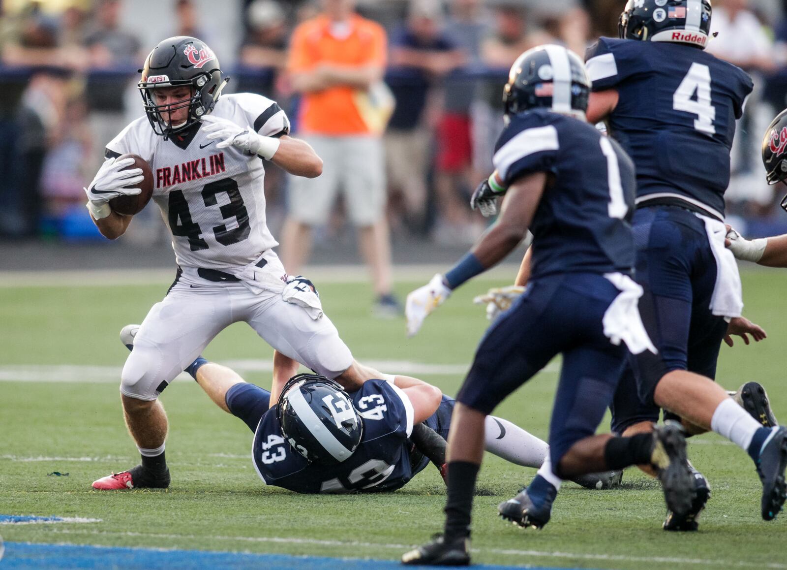 Edgewood's Kory McCall tries to tackle Franklin's Gage Johnson as he carries the ball during Friday night’s game at Kumler Field in St. Clair Township. NICK GRAHAM/STAFF