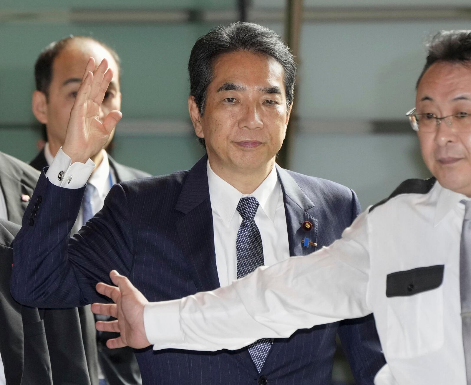 Japan's Agriculture Minister Taku Eto, center, arrives at the prime minister's office in Tokyo Wednesday, May 21, 2025. (Kyodo News via AP)