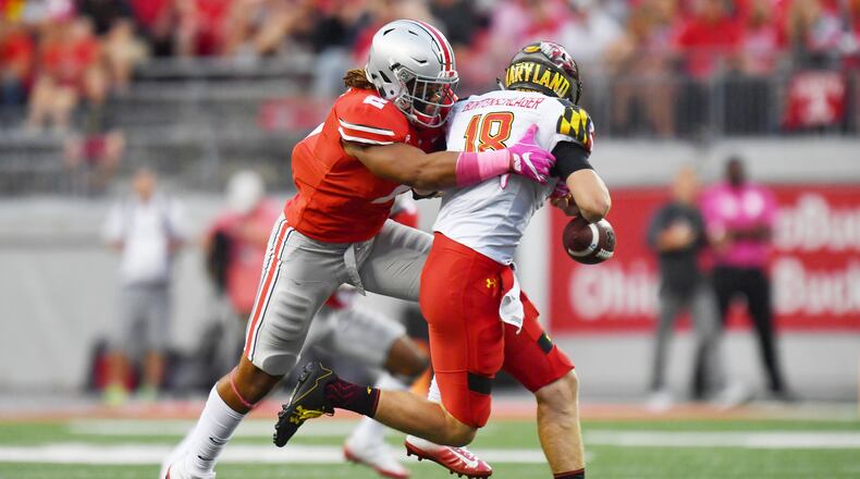 COLUMBUS, OH - OCTOBER 7: Chase Young #2 of the Ohio State Buckeyes hits quarterback Max Bortenschlager #18 of the Maryland Terrapins in the backfield causing a fumble in the third quarter at Ohio Stadium on October 7, 2017 in Columbus, Ohio. Ohio State defeated Maryland 62.14. (Photo by Jamie Sabau/Getty Images)