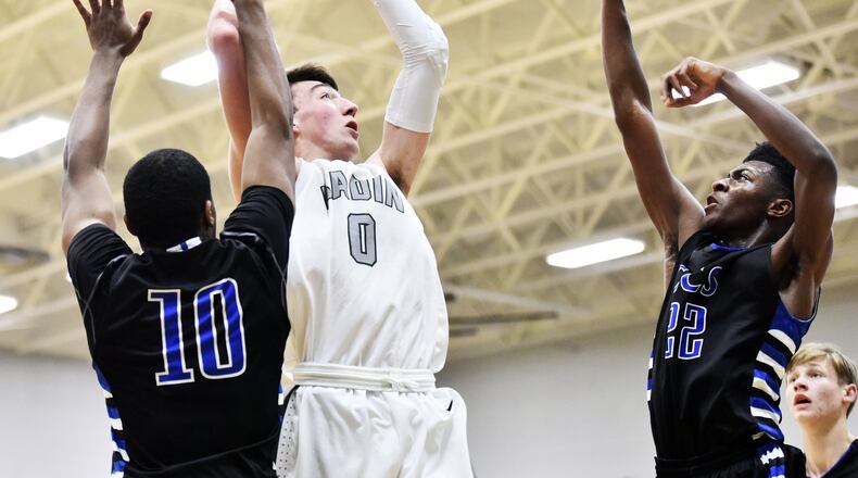 Badin’s Jakob Tipton goes up for a shot while being defended by Cincinnati Christian’s Cole Martin (10) and Josh Lawless (22) during their game Friday, Dec. 1 at Mulcahey Gym in Hamilton. NICK GRAHAM/STAFF