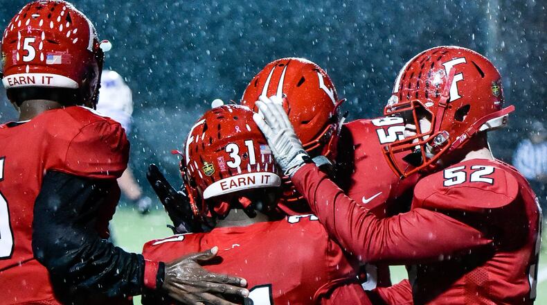 Fairfield’s Taimar Boykin (31) is greeted by teammates after scoring a touchdown during Friday night’s game against Middletown at Fairfield Stadium. NICK GRAHAM/STAFF