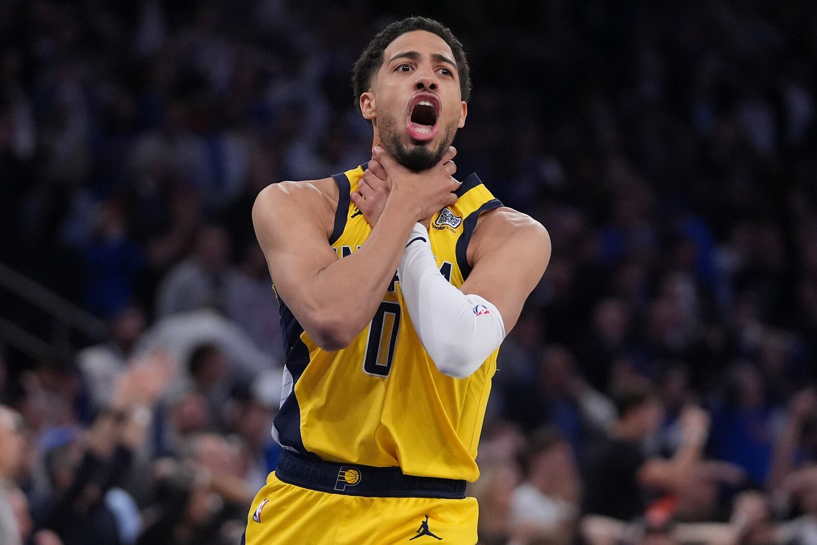 Indiana Pacers guard Tyrese Haliburton (0) makes a choke motion towards the New York Knicks after hitting a shot at the end of the fourth quarter of Game 1 of the NBA basketball Eastern Conference final, Wednesday, May 21, 2025, in New York. (AP Photo/Frank Franklin II)