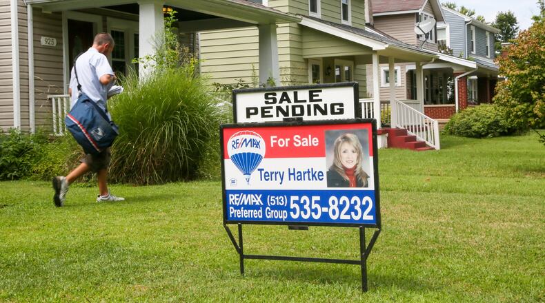 A home with a sale pending sign is seen Monday, Aug. 7, along Ridgelawn Avenue in Hamilton. Home sales, for Butler County and the region are continuing to hold steady through the first half of the year. GREG LYNCH / STAFF