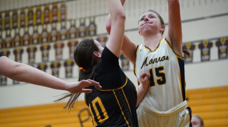 Monroe's Ryan Buskirk (15) puts up a shot over Taylor's Lizzy Hilvert (10) on Wednesday night at Western Brown. Chris Vogt/CONTRIBUTED