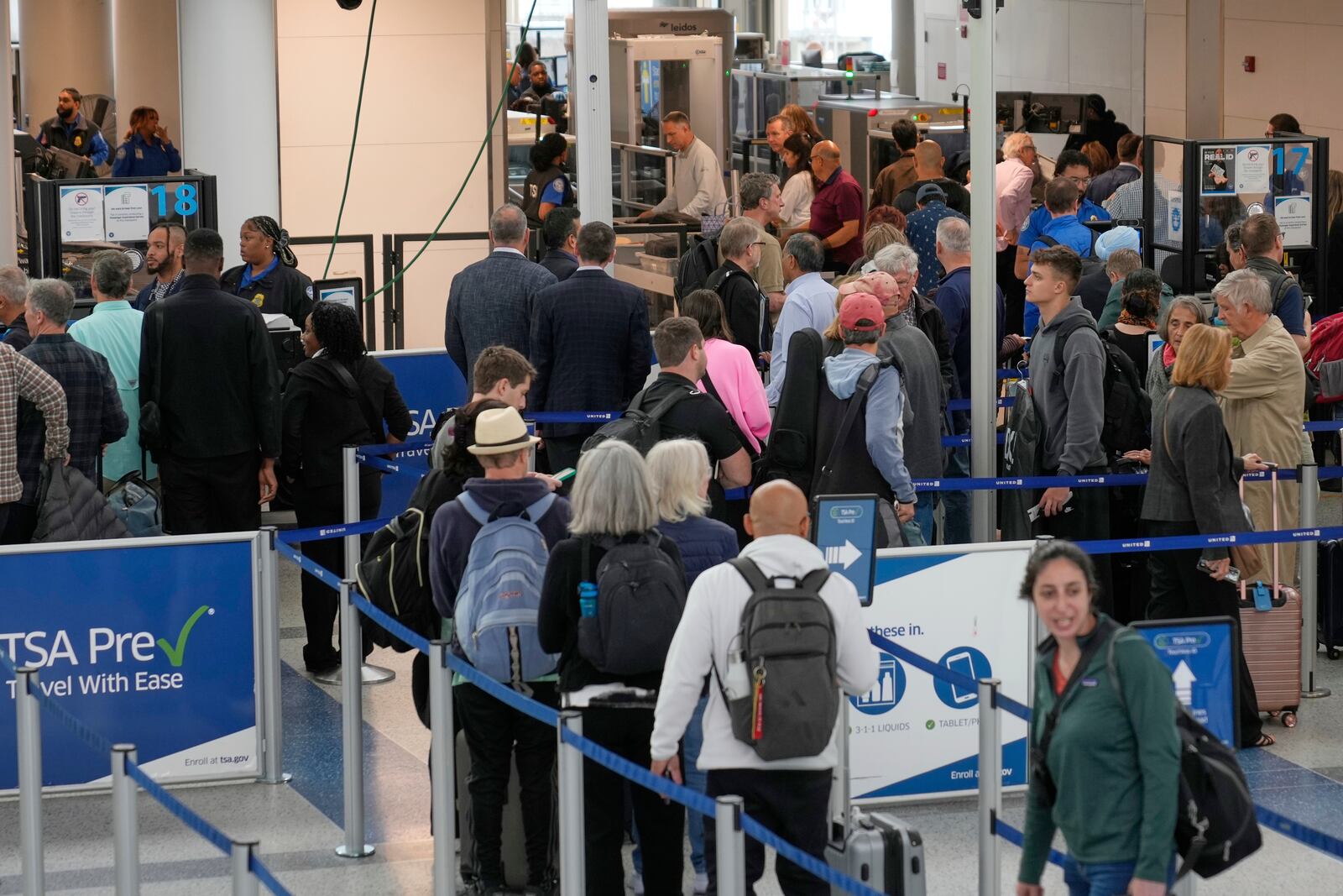 Travelers make their way through security at Newark Liberty International Airport in Newark, N.J., Monday, May 5, 2025. (AP Photo/Seth Wenig)