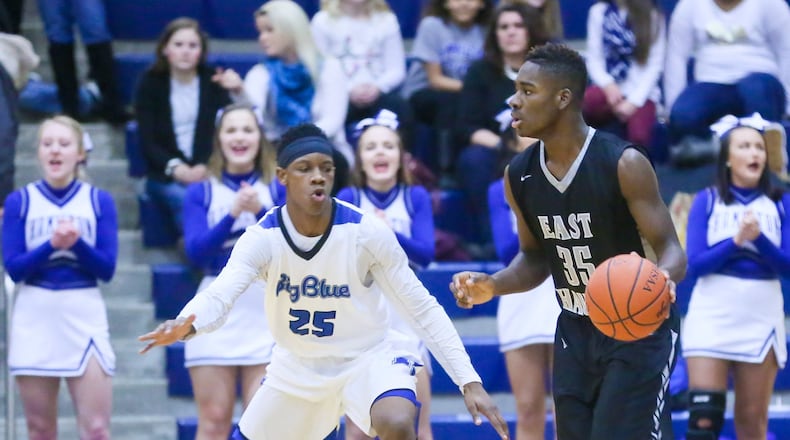 Lakota East guard Jarrett Cox (35) surveys the Hamilton defense and Big Blue’s D’Marco Howard during their game at the Hamilton Athletic Center on Feb. 10, 2017. GREG LYNCH/STAFF