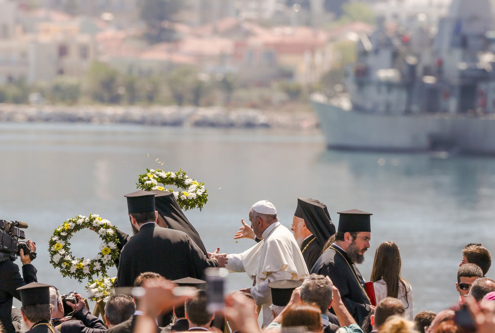 FILE - Pope Francis, center, Ecumenical Patriarch Bartholomew I, left, and Archbishop of Athens Ieronymos II, toss floral wreaths into the sea on the Greek island of Lesbos, April 16, 2016. (AP Photo/Petros Giannakouris, File)