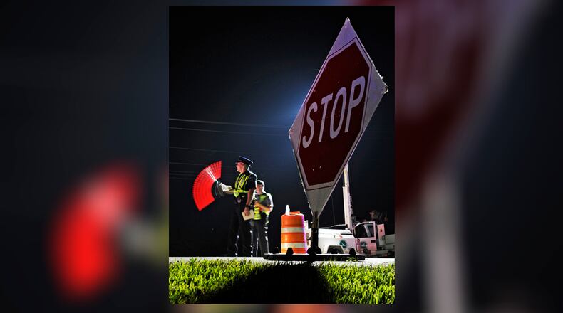 Officers from Monroe, Middletown and the Ohio State Highway Patrol participated in an OVI checkpoint Early Saturday morning, June 11, 2011 along OH-4 in Monroe, Ohio. Staff photo by Nick Graham