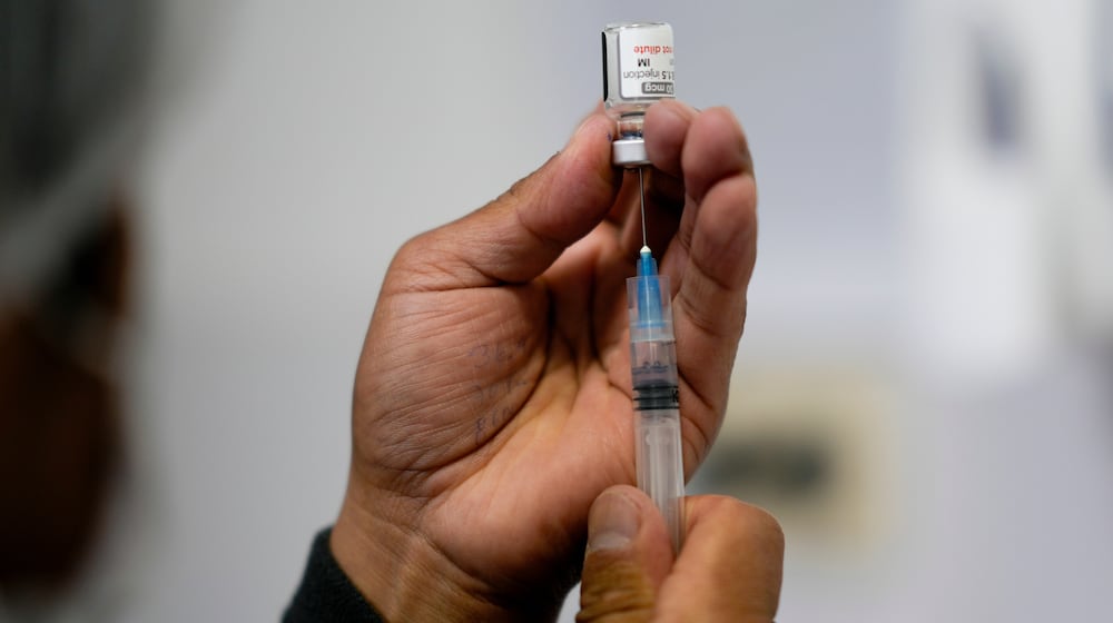 FILE - A healthcare worker prepares a shot of the Pfizer COVID-19 vaccine in La Paz, Bolivia, Jan. 7, 2025. (AP Photo/Juan Karita, File)
