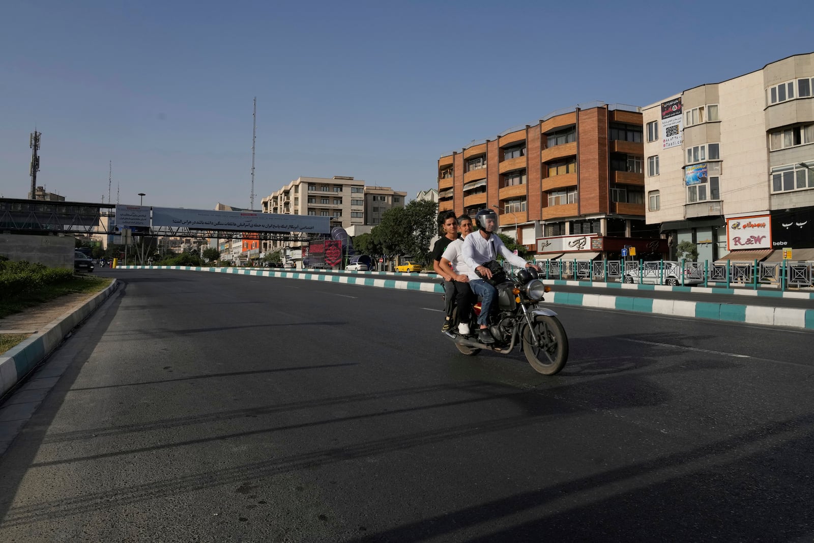 A motorbike drives in a quiet square in downtown Tehran, Iran, Monday, June 23, 2025. (AP Photo/Vahid Salemi)