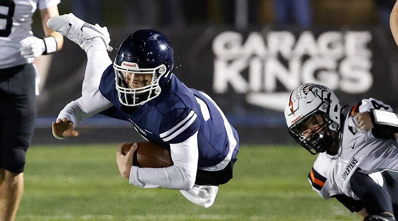 Valley View's Caden Henson hangs in the aiir after being tripped up by Waynesville's Connor Berrey during their playoff game at Spingboro Friday, Nov. 17, 2023. BILL LACKEY/STAFF