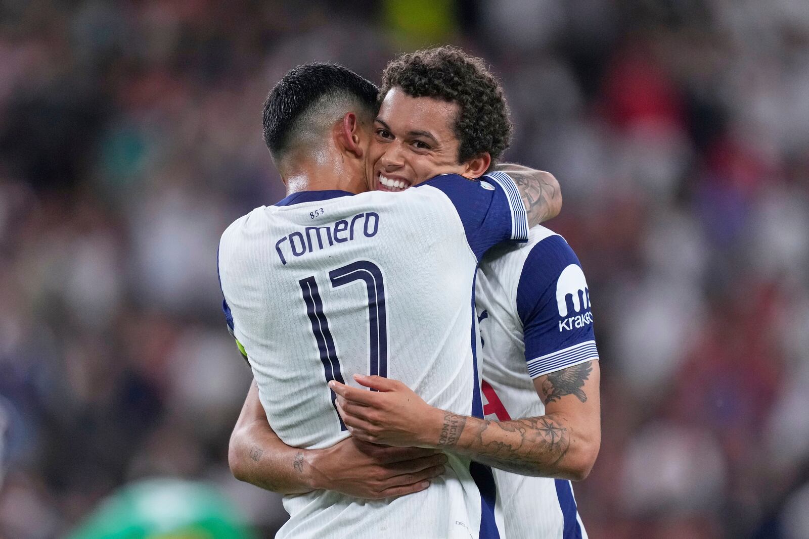 Tottenham's Brennan Johnson, right, celebrates with Tottenham's Cristian Romero after scoring his side's opening goal during the Europa League final soccer match between Tottenham Hotspur and Manchester United at the San Mames Stadium in Bilbao, Spain, Wednesday, May 21, 2025. (AP Photo/Jose Breton)