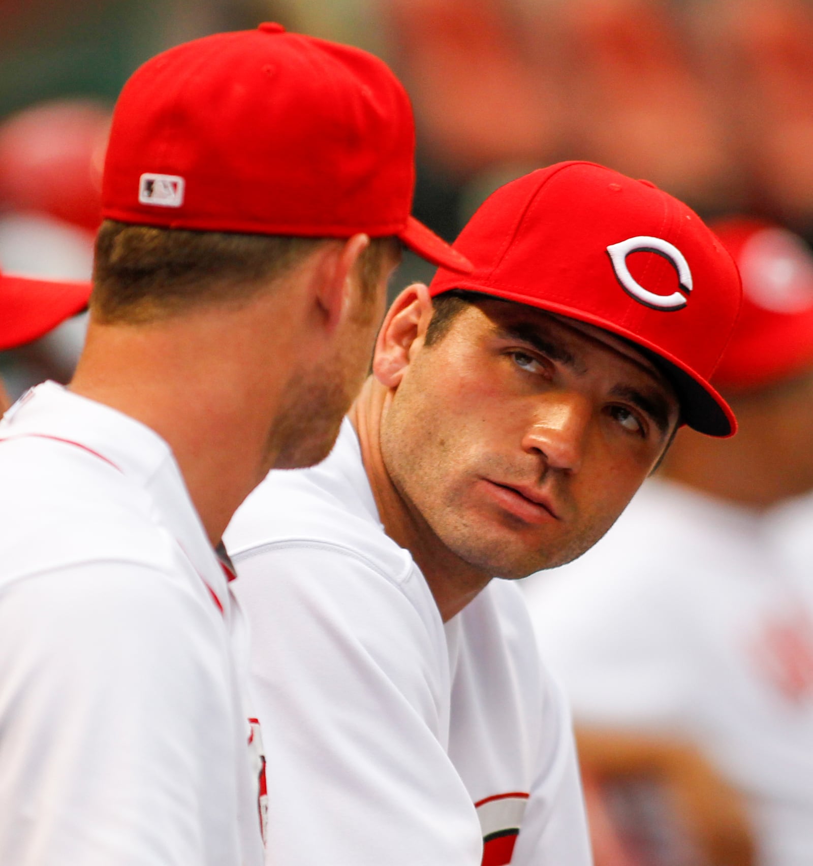 Reds first baseman Joey Votto talks to teammate Ryan Ludwick during a game against the Cubs on Monday, July 7, 2014, at Great American Ball Park in Cincinnati. David Jablonski/Staff