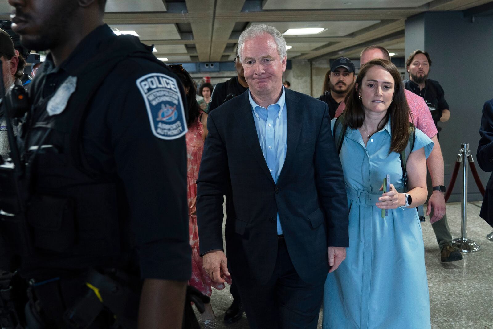 Sen. Chris Van Hollen, D-Md., left, walks in the terminal after speaking during a news conference upon his arrival from meeting with Kilmar Abrego Garcia in El Salvador, at Washington Dulles International Airport, in Chantilly, Va., Friday, April 18, 2025. (AP Photo/Jose Luis Magana)