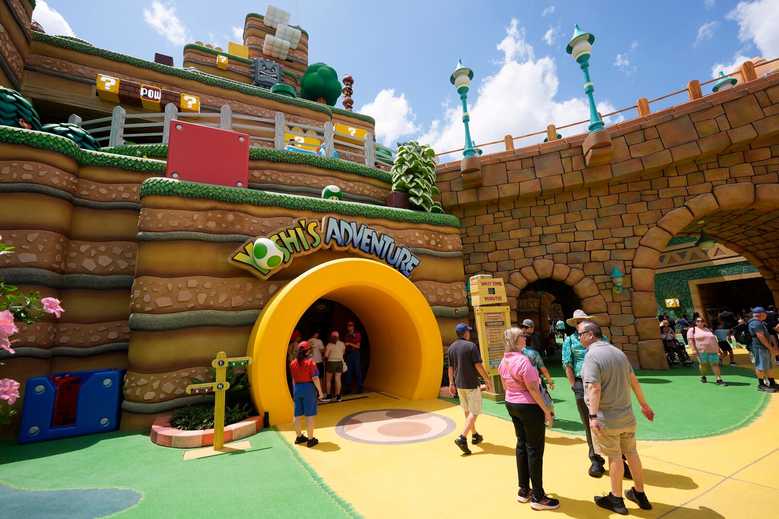 Guests stroll around the various parts of Super Nintendo World at Epic Universe at Universal Resort Orlando Thursday, April 10, 2025, in Orlando, Fla. (AP Photo/John Raoux)