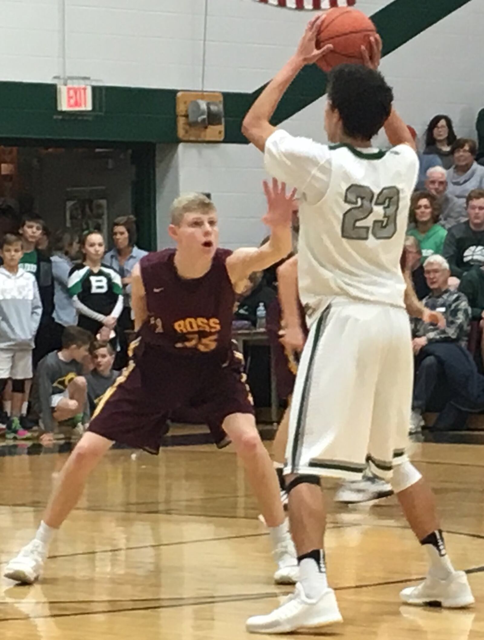 Cody Geers (35) of Ross defends Badin’s Caleb Meyer (23) on Saturday night at Mulcahey Gym in Hamilton. RICK CASSANO/STAFF