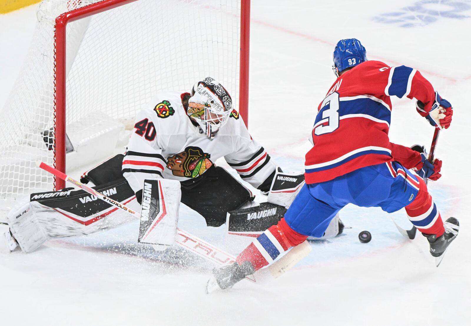 Montreal Canadiens' Ivan Demidov (93) moves in to score against Chicago Blackhawks goaltender Arvid Soderblom (40) during first-period NHL hockey game action in Montreal, Monday, April 14, 2025. (Graham Hughes/The Canadian Press via AP)
