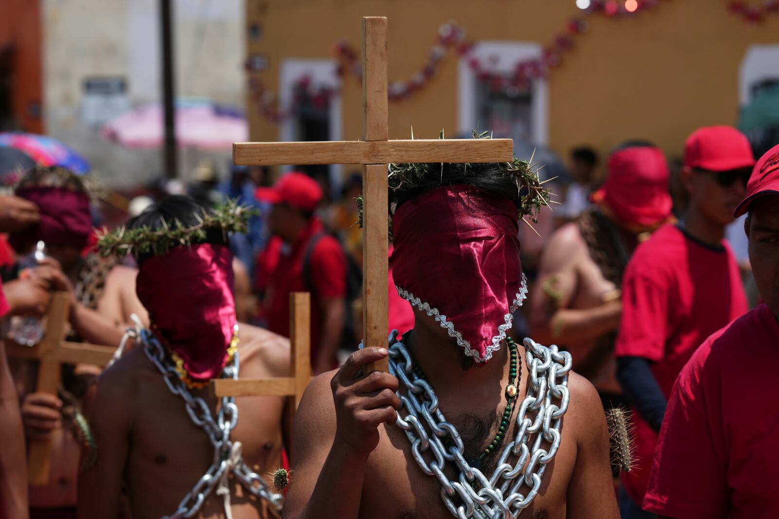 Masked penitents take part in a Holy Week procession in Atlixco, Mexico, on Good Friday, April 18, 2025. (AP Photo/Eduardo Verdugo)