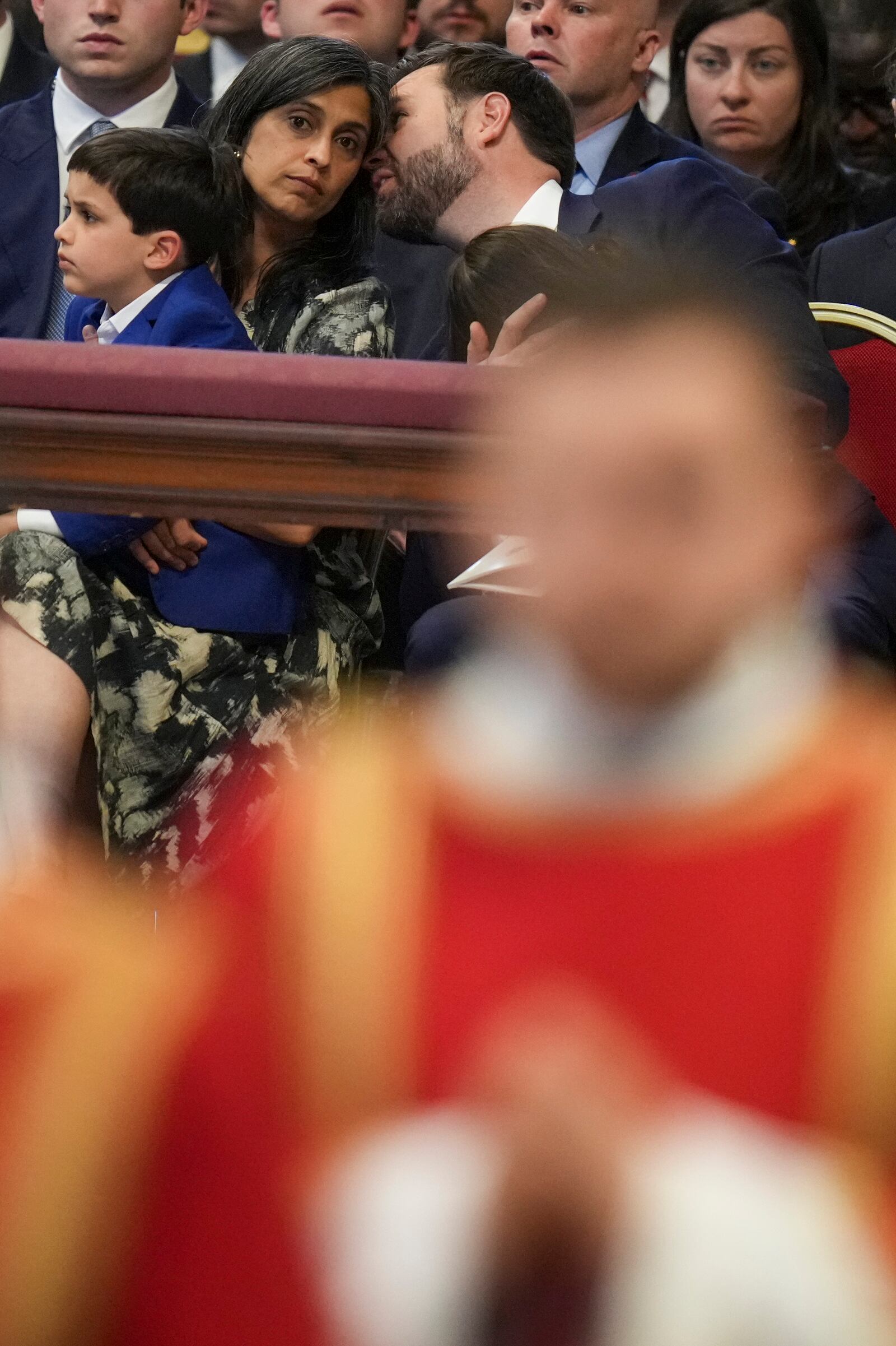 U.S. Vice President JD Vance attends with his wife Usha and son Vivek, left, a Good Friday service inside St. Peter's Basilica at the Vatican, Friday, April 18, 2025. (AP Photo/Alessandra Tarantino)