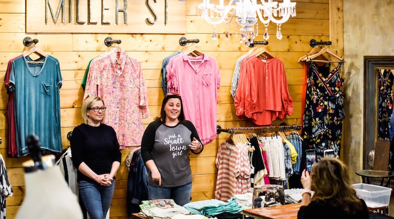Tara Smithson, left, and Stephanie Gonya, co-owners of Miller St. Boutique on Nilles Road in Farifield, go live on Facebook and Instagram Monday, May 11, 2020 to talk about opening their retail shop to customers on Tuesday. They have increased their online presence since they have been closed almost two months due to the coronavirus pandemic. NICK GRAHAM / STAFF