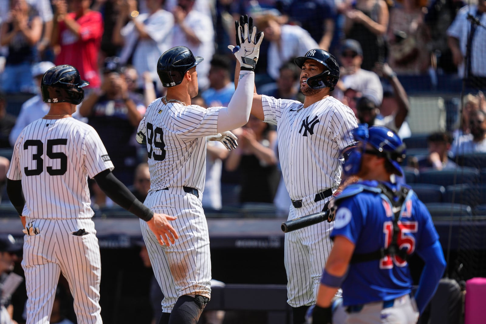 New York Yankees' Aaron Judge (99) celebrates with designated hitter Giancarlo Stanton (27) after hitting a two run home run during the ninth inning of a baseball game against the Chicago Cubs, Saturday, July 12, 2025, in New York. (AP Photo/Yuki Iwamura)