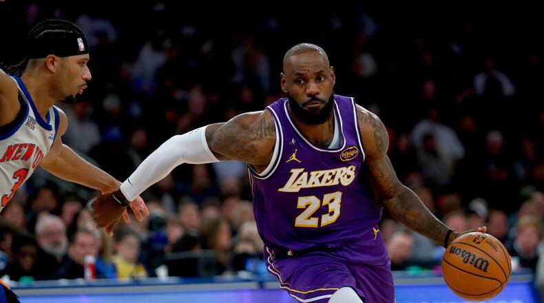 New York Knicks guard Josh Hart, left, defends against Los Angeles Lakers forward LeBron James, right, during the second half of an NBA basketball game, Sunday, Feb. 1, 2026, in New York. (AP Photo/John Munson)