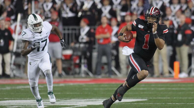 Ohio State’s Justin Fields runs as Michigan State’s Tyriq Thompson pursues him on Saturday, Oct. 5, 2019, at Ohio Stadium in Columbus. David Jablonski/Staff