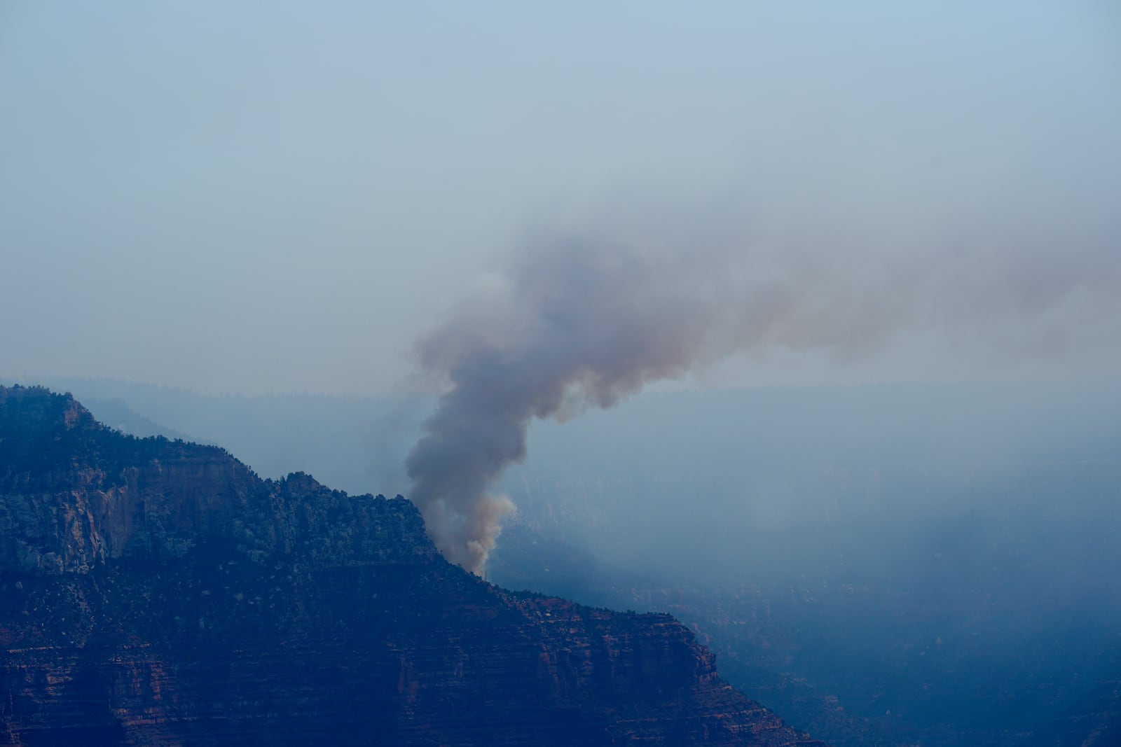 Smoke from the Dragon Bravo Fire moves over the Grand Canyon along the North Rim Tuesday, July 15, 2025, in Grand Canyon National Park, Ariz. (AP Photo/Ross D. Franklin)