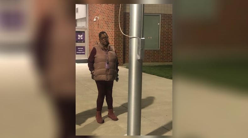 Shurine Winston, a paraprofessional at Middletown High School, prays near the school's flag pole. She has prayed there every school day for the last two years. RICK McCRABB/STAFF