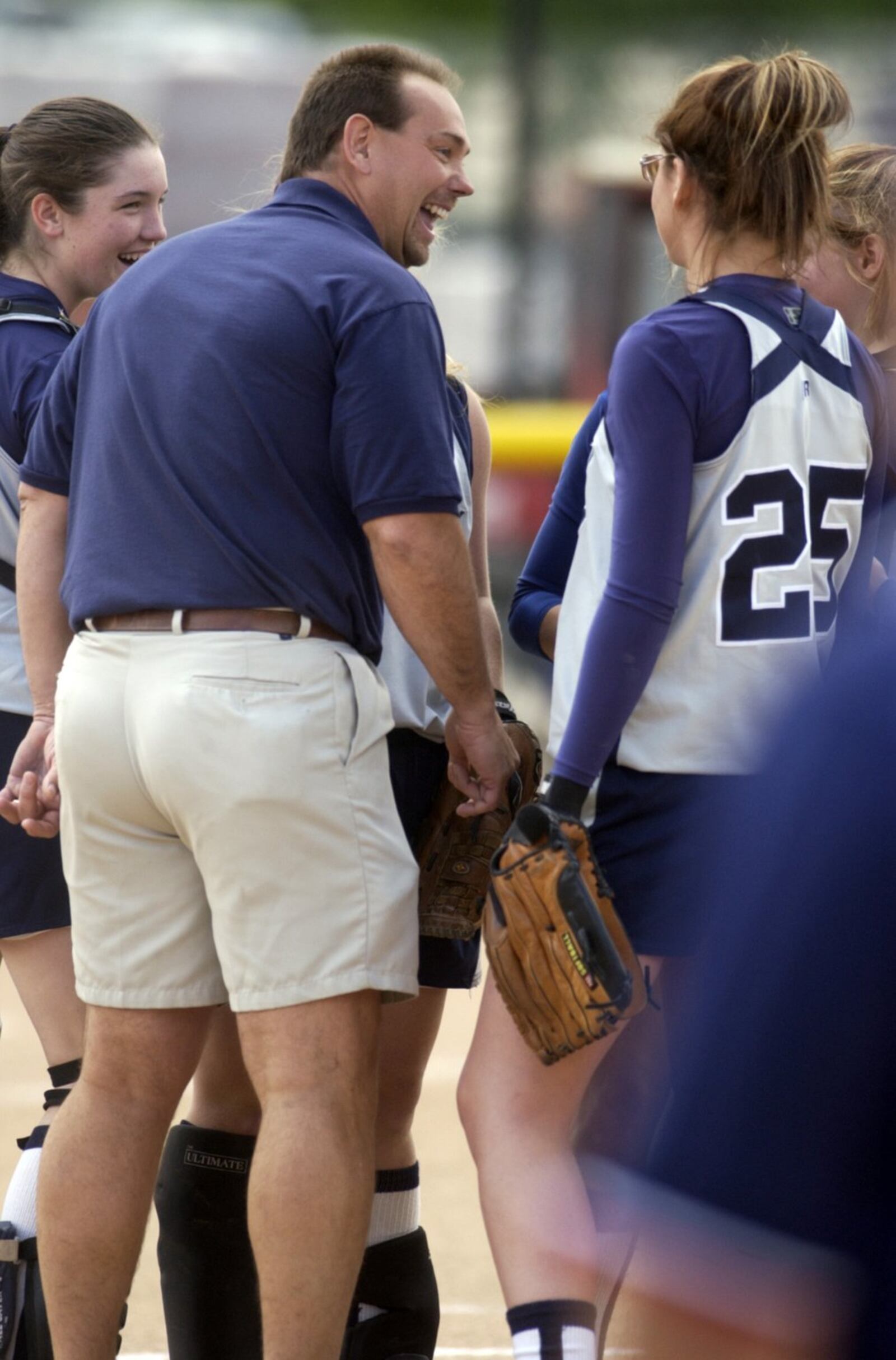 Edgewood coach Wayne Asher shares a light moment with players before the last out of their Division II tournament game against Springfield Kenton Ridge at Miami University in 2005. GREG LYNCH/STAFF