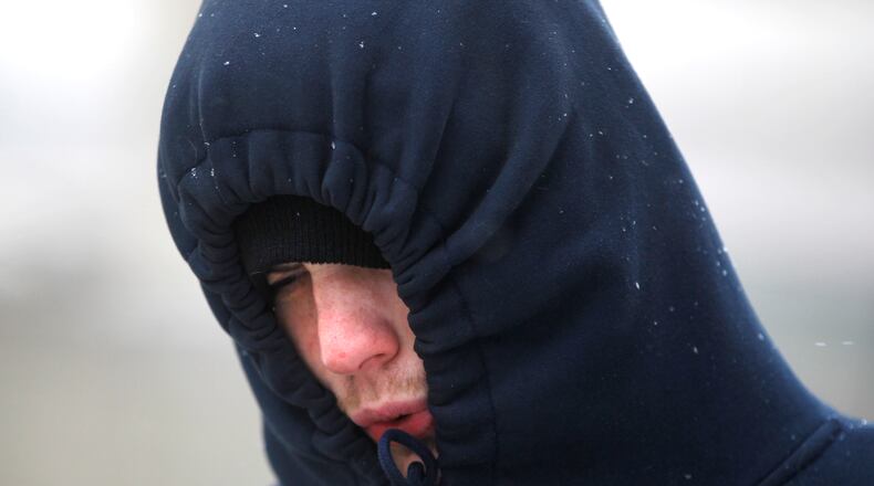 Robert Hixenbaugh of Dayton bundled up against the cold Friday. The National Weather Service has issued a Winter Storm Warning for much of Southwest Ohio and the Miami Valley until 1 a.m. Saturday. LISA POWELL / STAFF