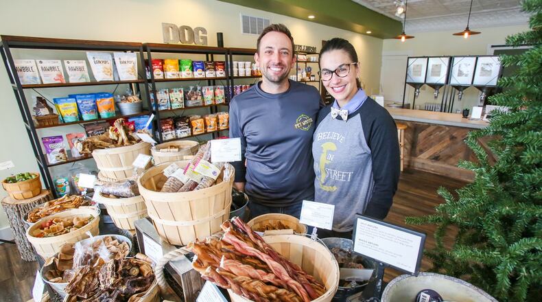Chris Miller and Rachel Steinman, owners of Pet Wants Hamilton, in their 139 Main St. store, Thursday, Sept. 14, 2017. GREG LYNCH / STAFF