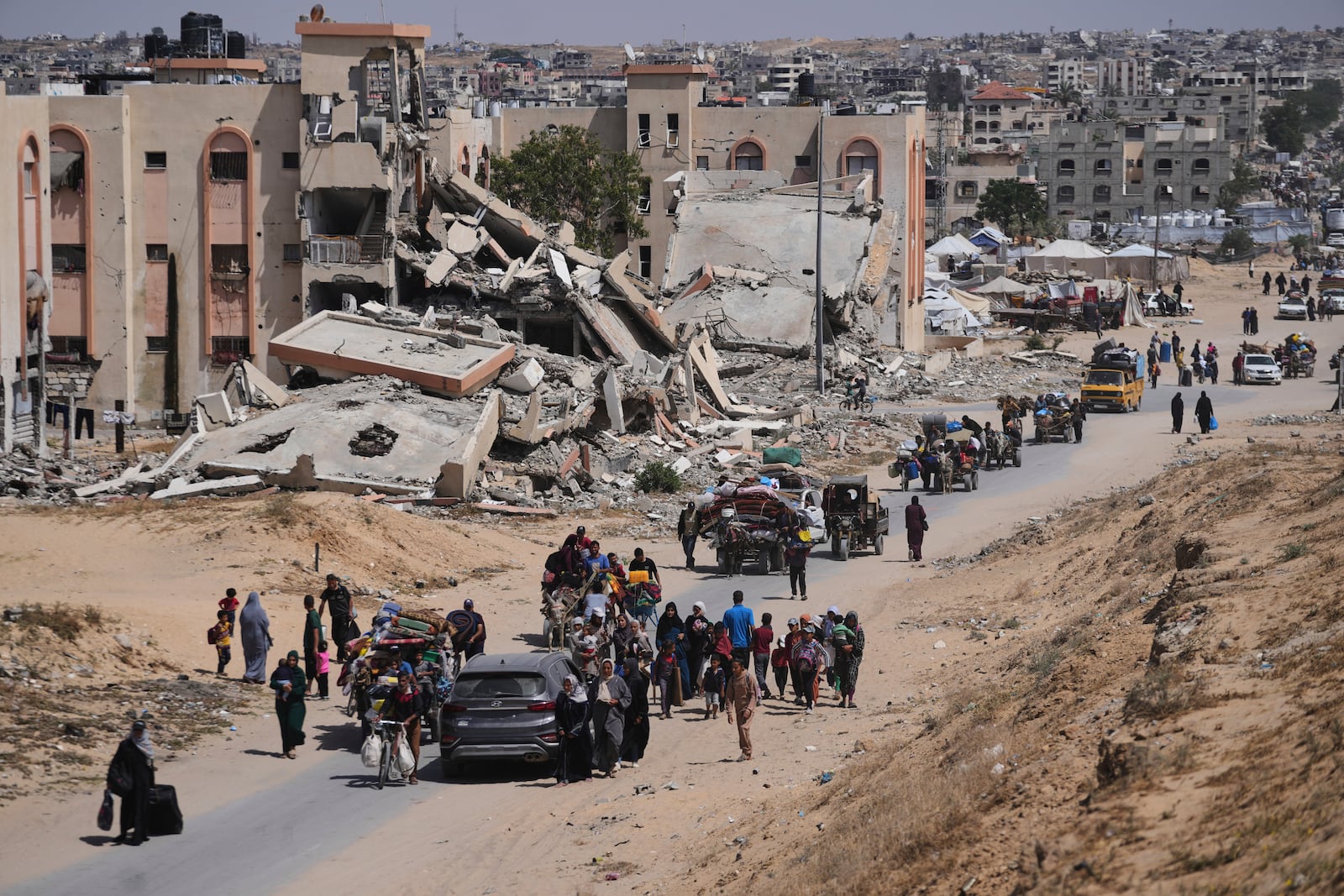 Displaced Palestinians flee from Khan Younis, Gaza, amid the ongoing Israeli military offensive in the area, on Monday, May 19, 2025. (AP Photo/Abdel Kareem Hana)