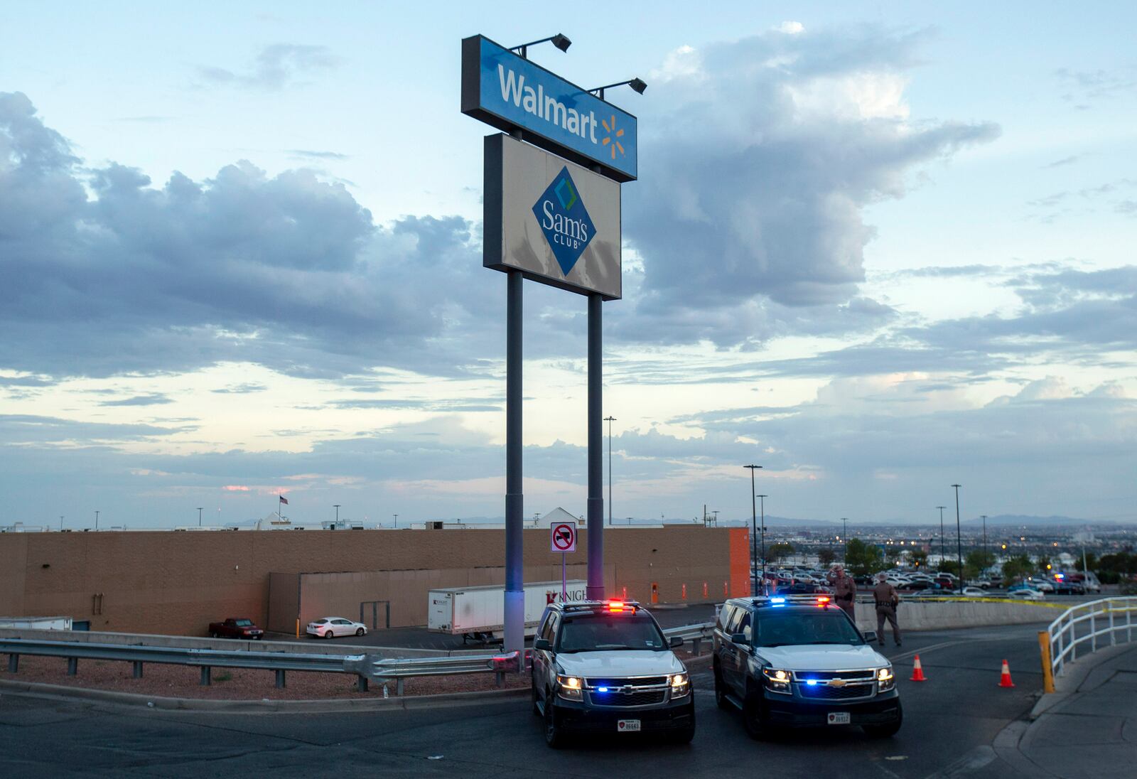 FILE - In this Aug. 3, 2019, photo Texas state police cars block the access to the Walmart store in the aftermath of a mass shooting in El Paso, Texas. (AP Photo/Andres Leighton, File)