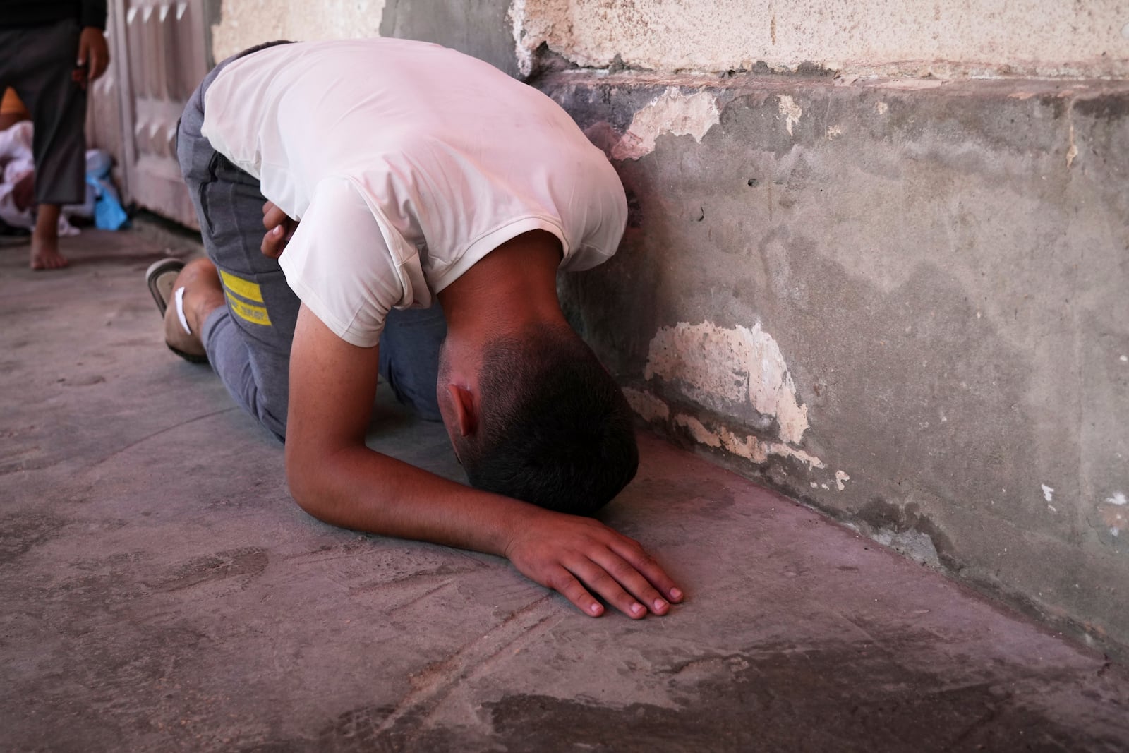 Youssef Abd Rabbo weeps at the hospital where the body of his mother Manal was taken together with 10 more people, including two women and five children, killed in an Israeli strike while they were waiting to receive nutritional supplements at a Project Hope-run medical clinic in Deir al-Balah, Gaza Strip, Thursday, July 10, 2025.(AP Photo/Abdel Kareem Hana)