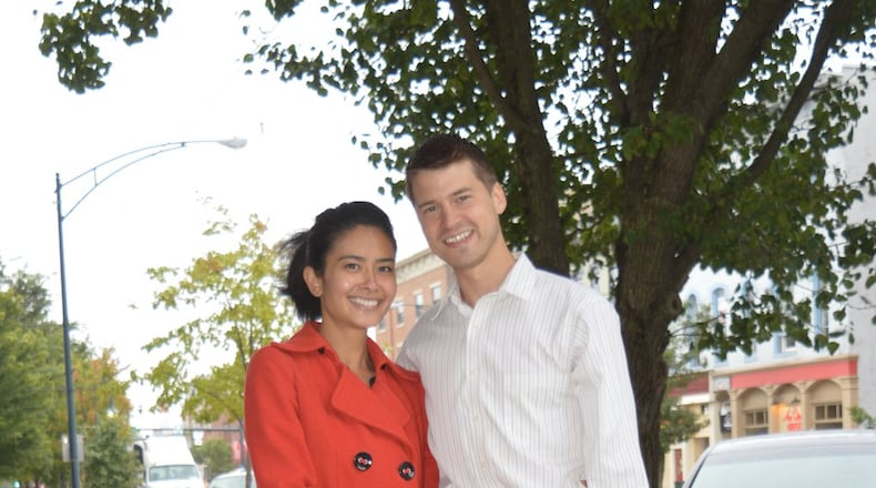 Chantel Raghu and Chris Reagh met in veterinary school and married before moving to Oxford last year where he joined his father’s veterinary practice and she commutes to her job at a vet clinic in Blue Ash. They are pictured on High Street with their rescue dog, Kai, a collie mix. CONTRIBUTED/BOB RATTERMAN