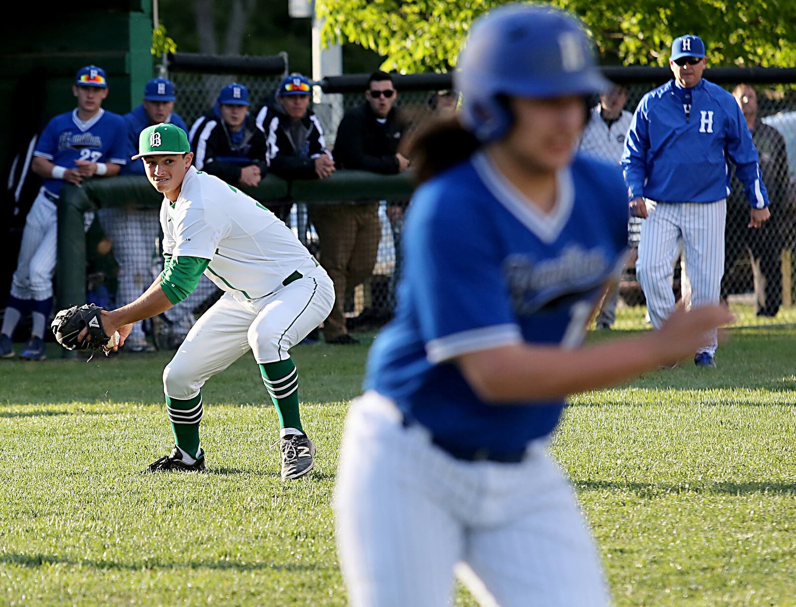 Badin pitcher Cameron Madden fields a bunt from Hamilton batter Jack Schlichter and makes a throw to first base Saturday night at Alumni Field in Hamilton. CONTRIBUTED PHOTO BY E.L. HUBBARD
