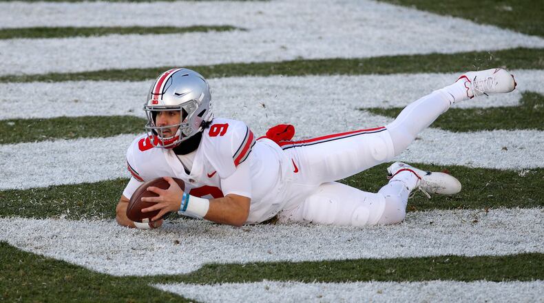 Ohio State quarterback Jack Miller III falls on the ball in the end zone for a safety after the snap went over his head during the second half of an NCAA college football game against Michigan State, Saturday, Dec. 5, 2020, in East Lansing, Mich. (AP Photo/Al Goldis)